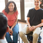 Group of diverse teens sitting in folding chairs in a circle