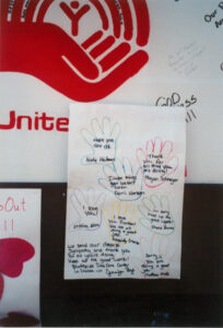 Additional notes of support attached to the "United We Stand" community billboard; outside of the La Crosse Center; October 11, 2001.